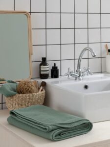 Salle de bain moderne avec miroir et accessoires.