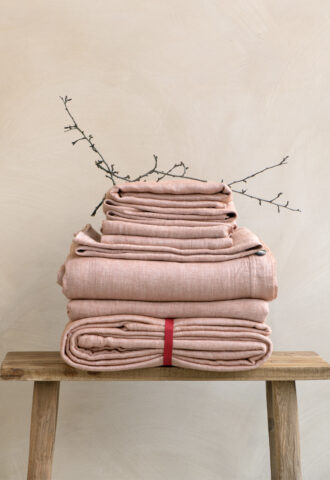 Folded linens on a wooden bench
