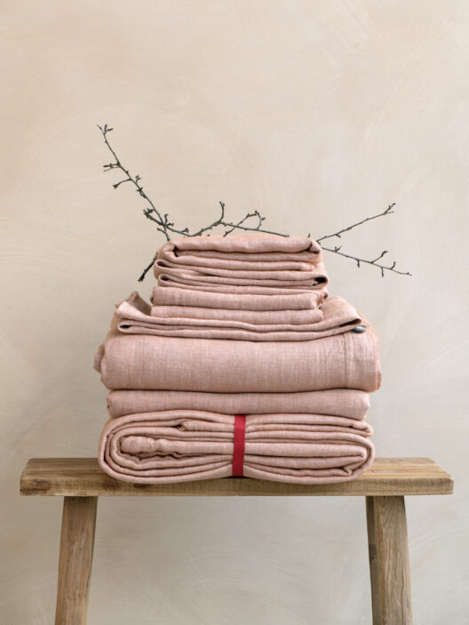 Folded linens on a wooden bench